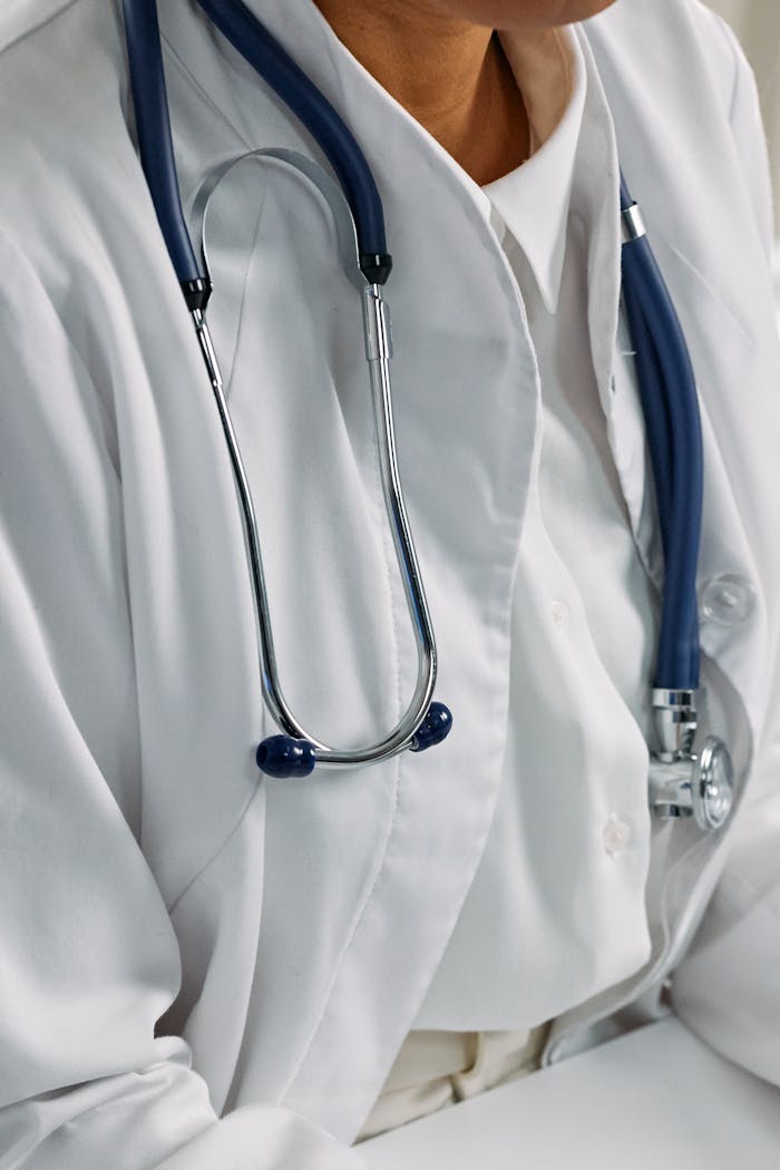cta-02 Close-up of a healthcare professional's stethoscope draped around a white coat, symbolizing clinical care.